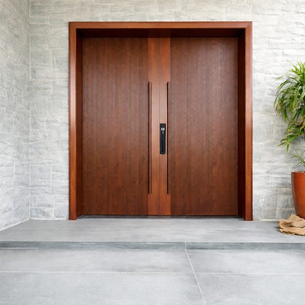 A tall double teak entrance door