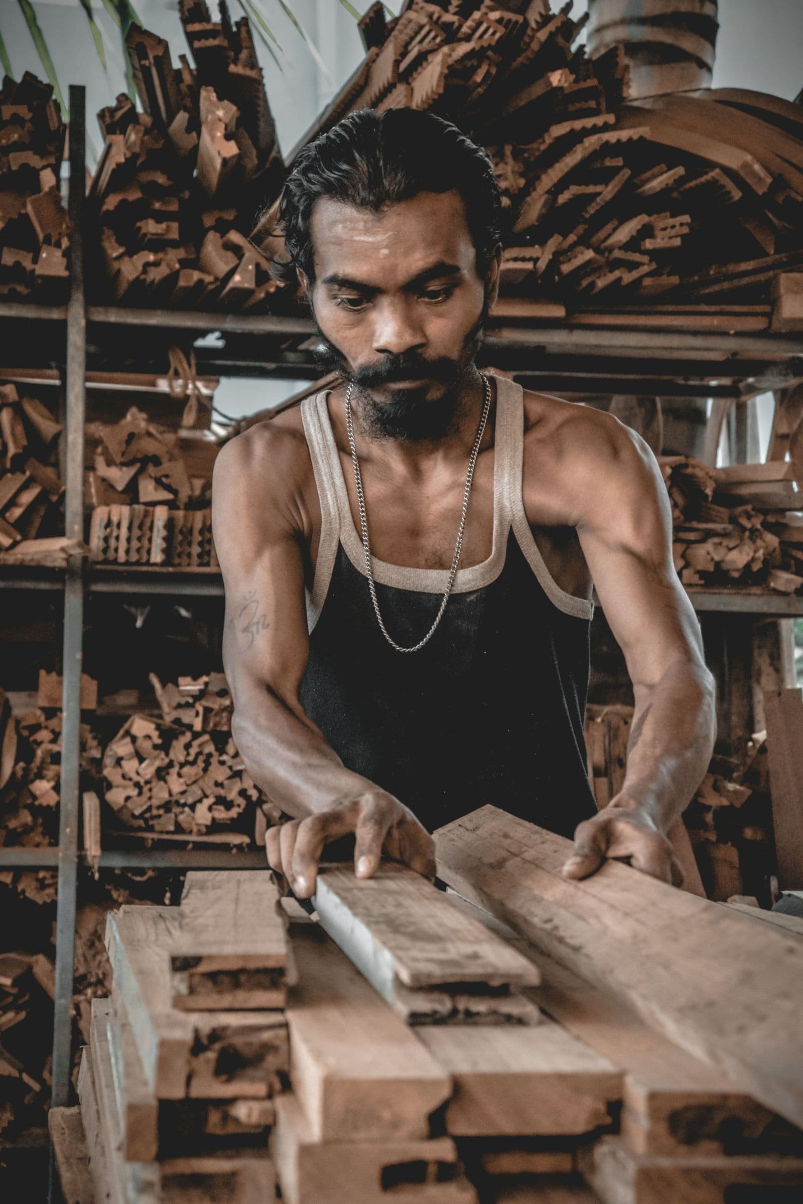 A carpenter planing timber