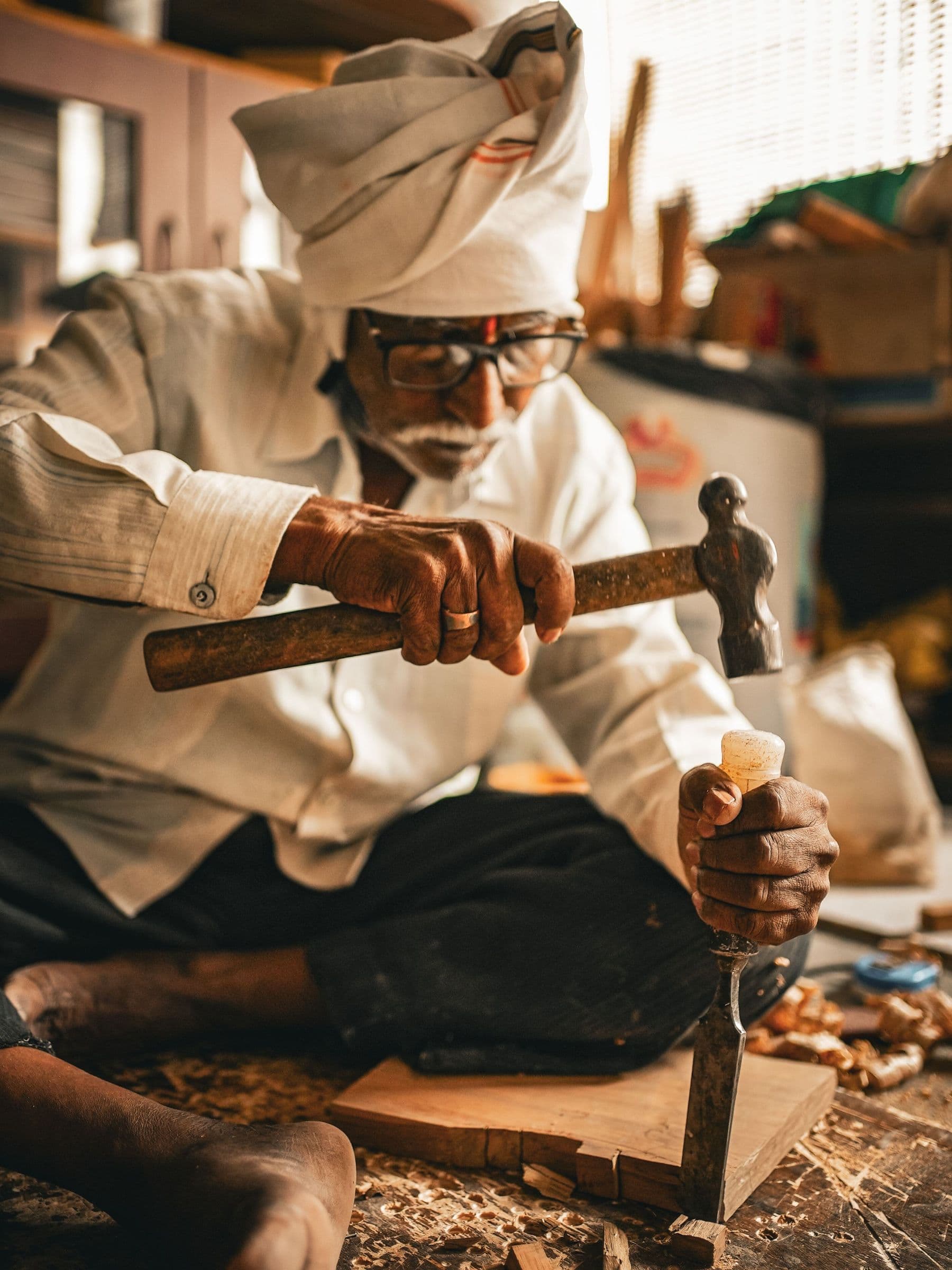 A craftsman chiselling timber