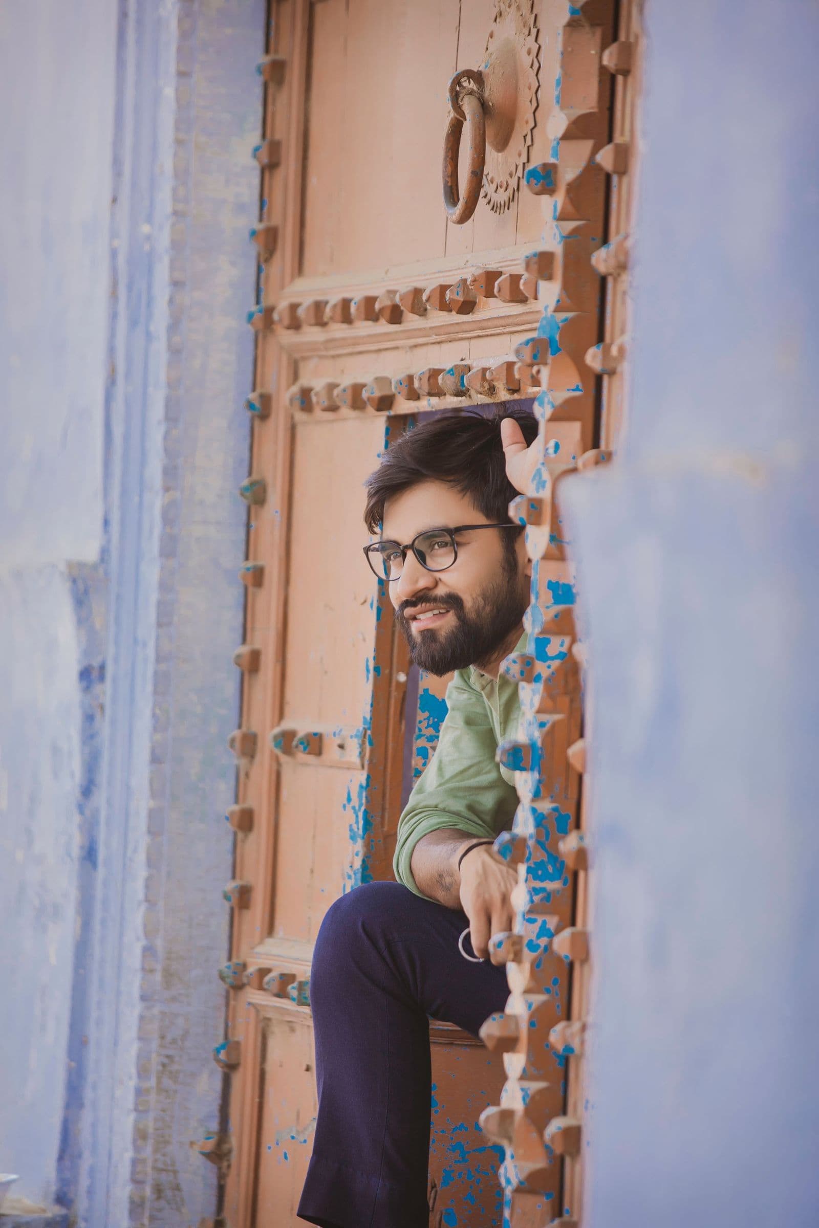 A man at a carved wooden door