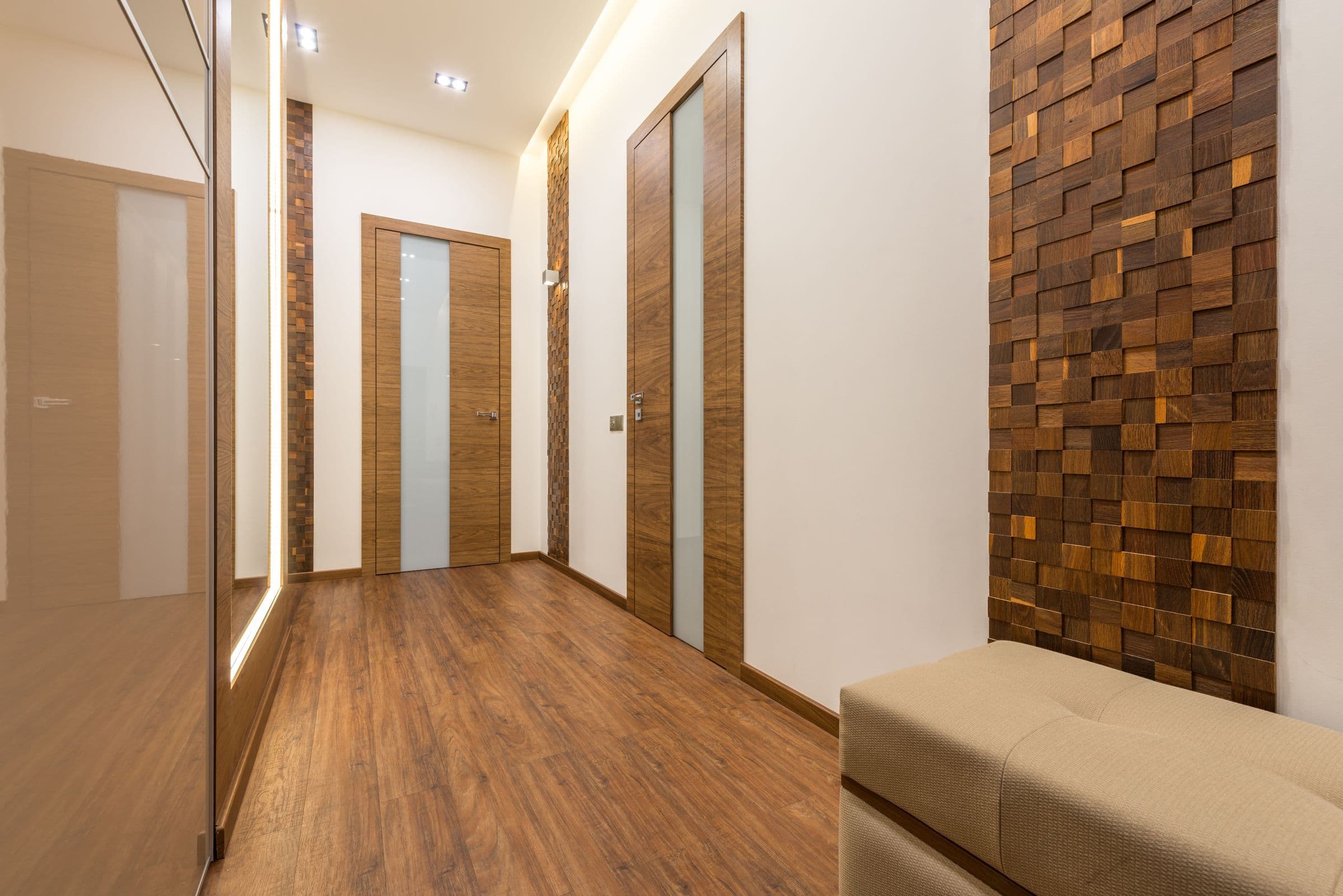 A hallway lined with timber doors